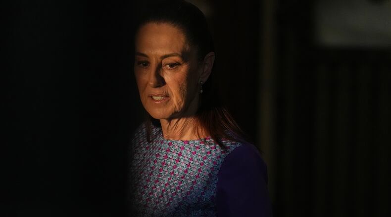 Mexican President Claudia Sheinbaum arrives at the National Palace to give her daily morning press conference in Mexico City, Thursday, April 30, 2026. (AP Photo/Fernando Llano)