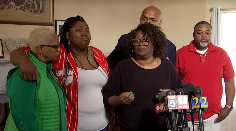 Sheryl Calhoun (third from left) talks to reporters about the death of her husband Charles Calhoun, who was shot and killed by Clayton County police outside the couple's Jonesboro home early March 23. She's joined by family members and Mawuli Davis, a Decatur attorney representing the family.