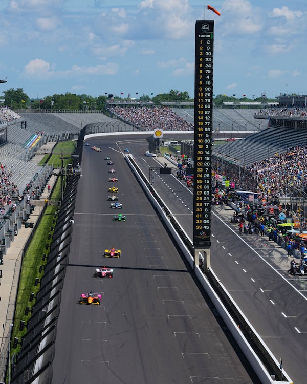 Devlin DeFrancesco, of Canada, leads a pack of cars during practice for the Indianapolis 500 auto race at Indianapolis Motor Speedway in Indianapolis, Friday, May 23, 2025. (AP Photo/Michael Conroy)