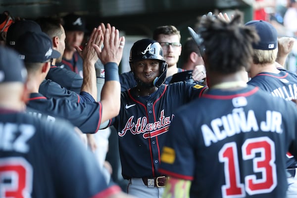 Atlanta Braves' Jurickson Profar celebrates with his teammates after hitting a two-run home run during the third inning of a baseball game against the Athletics, Thursday, July 10, 2025, in West Sacramento, Calif. (AP Photo/Scott Marshall)
