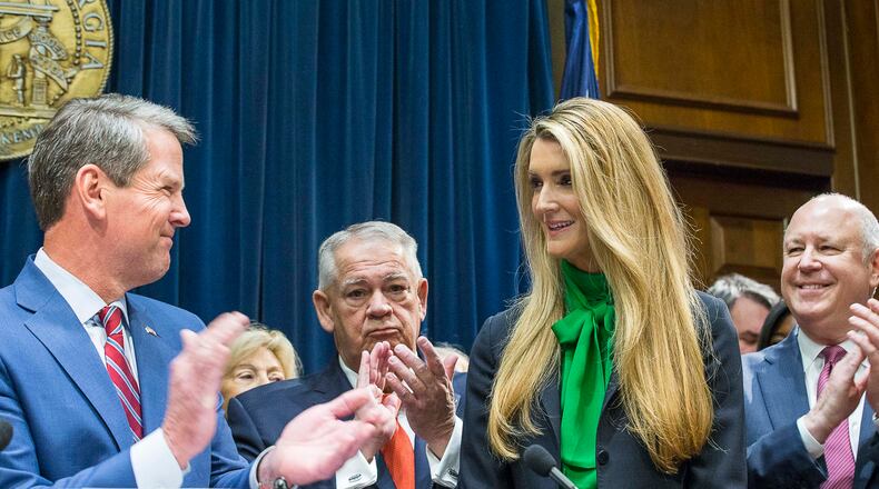 12/04/2019 -- Atlanta, Georgia -- Lawmakers applaud as newly appointed U.S. Senator Kelly Loeffler (second from right) is introduced by Georgia Gov. Bria Kemp (left) during a press conference in the Governor's office at the Georgia State Capitol Building, Wednesday, December 4, 2019. Georgia Gov. Brian Kemp appointed Kelly Loeffler to the U.S. Senate to take the place of U.S. Senator Johnny Isakson, who is stepping down for health reasons. (ALYSSA POINTER/ALYSSA.POINTER@AJC.COM)