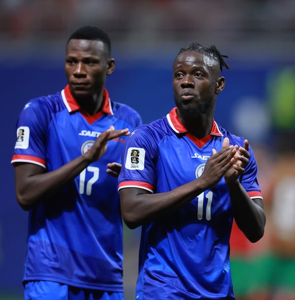 Haiti's Louicius Deedson, right, and teammate Danley Jean Jacques appplaud following their loss against Morocco in Group C FIFA World Cup match at Atlanta Stadium (Mercedes-Benz Stadium) on Wednesday, June 24, 2026.  (Jason Getz/AJC)