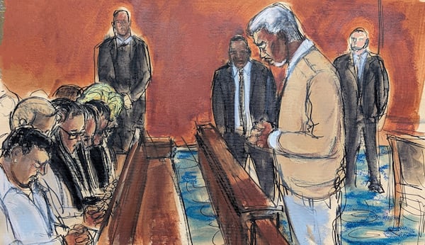 In this courtroom sketch, Sean "Diddy" Combs, rights, leads his family in a prayer before the verdict was read, convicting him of prostitution-related offenses but acquitting him of sex trafficking and racketeering charges, Wednesday, July 2, 2025, in Manhattan federal court in New York. (Elizabeth Williams via AP)