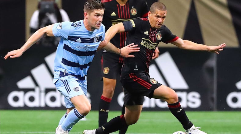 Atlanta United midfielder Ozzie Alonso (right) works against Sporting KC in a MLS soccer match Sunday, Feb. 27, 2022, in Atlanta.  “Curtis Compton / Curtis.Compton@ajc.com”`