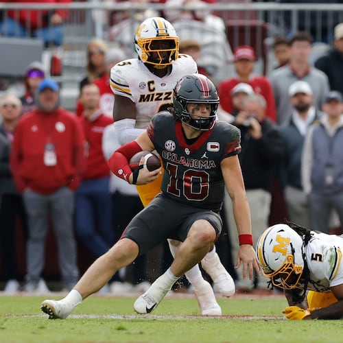 Oklahoma quarterback John Mateer (10) runs the ball past Missouri linebacker Khalil Jacobs (5) during the second half of an NCAA college football game Saturday, Nov. 22, 2025, in Norman, Okla. (AP Photo/Alonzo Adams)