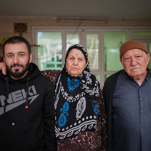 Syrian refugee Mohammed Dawood, 30, left, poses for a photo with his parents, Hayat Fatah, 65, center, and Abdulilah Amin Dawoud, 73, at their home in Irbil, Iraq, Nov. 16, 2025. (AP Photo/Farid Abdulwahed)