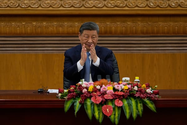 Chinese President Xi Jinping applauds during a meeting with international business representatives at the Great Hall of the People in Beijing on Friday, March 28, 2025. (AP Photo/Ng Han Guan)