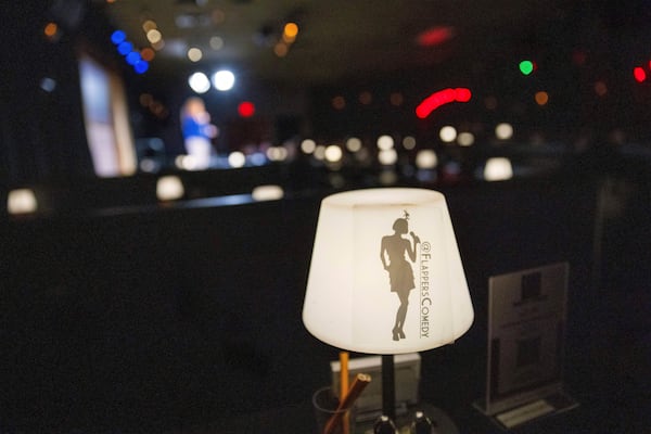 A light with the name Flappers Comedy is visible as Ashley Brooke Roberts performs during Stand Up For Climate on Thursday, March 20, 2025, in Burbank, Calif. (AP Photo/Ethan Swope)