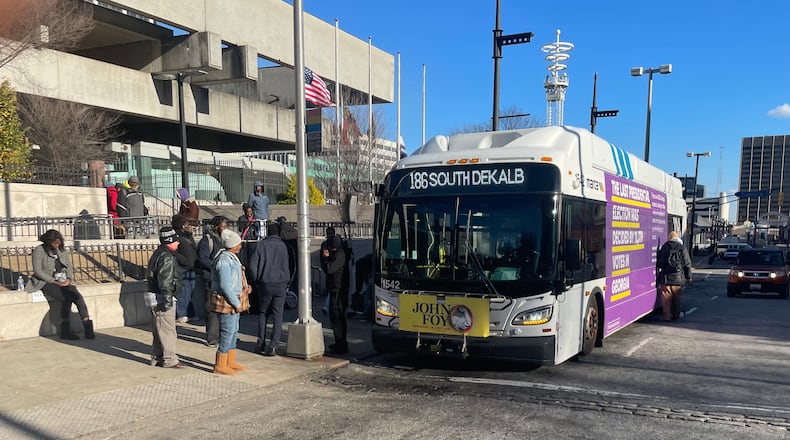 MARTA has stopped allowing lawyers, massage parlors and several other businesses from advertising on the agency's vehicles. Lawyer John Foy has placards on the front of more than 400 of the 500-plus buses in the MARTA fleet. (Bill Torpy/AJC)