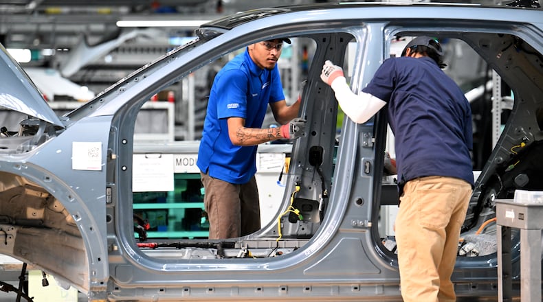 Workers check a Hyundai IONIQ 5 on the EV assembly line at Hyundai Motor Group Metaplant America in Ellabell near the Georgia coastal city of Savannah on Wednesday, May 6, 2026. (Hyosub Shin/AJC)