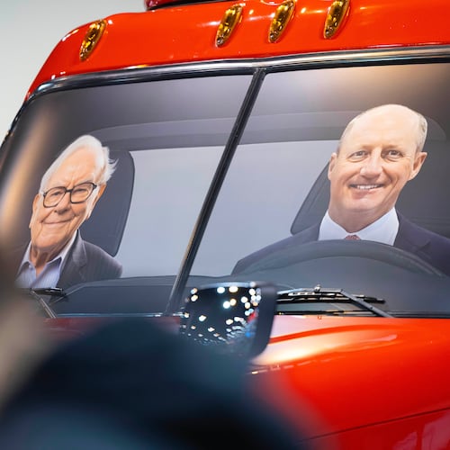 FILE - Portraits of Berkshire Hathaway's Warren Buffett, left, and CEO Greg Abel sit in a semi truck at the Pilot display in the Berkshire Hathaway annual meeting on May 2, 2026, in Omaha, Neb. (AP Photo/Rebecca S. Gratz, file)