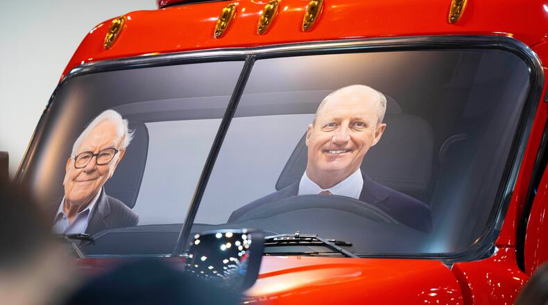 FILE - Portraits of Berkshire Hathaway's Warren Buffett, left, and CEO Greg Abel sit in a semi truck at the Pilot display in the Berkshire Hathaway annual meeting on May 2, 2026, in Omaha, Neb. (AP Photo/Rebecca S. Gratz, file)