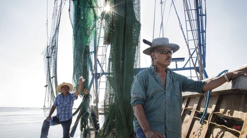 On Sept. 12, 2017, Benny Torres (front) and his cousin Agustin Tovar repaired their nets which were damaged by Hurricane Harvey during the week of Aug. 25th. Typically, the pair fish for shrimp in their hometown, Seadrift, TX, but after the storm upset their catch, they tried their hand in Indianola, TX where they were similarly unlucky. “It’s the only job we got, so we’ve got to do something,” said Torres. (RESHMA KIRPALANI / AMERICAN-STATESMAN)