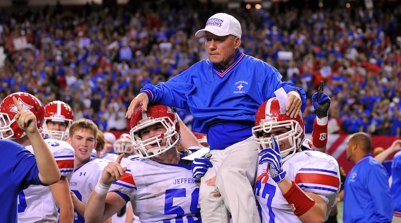 Jefferson head coach T. McFerrin is carried onto the field by Jordan Tyler (left) and Conner Nations.