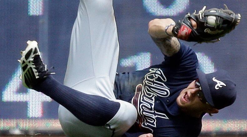 Atlanta Braves' Jordan Schafer makes a diving catch on a ball hit by Milwaukee Brewers' Jeff Bianchi during the sixth inning of a baseball game on Sunday, June 23, 2013.