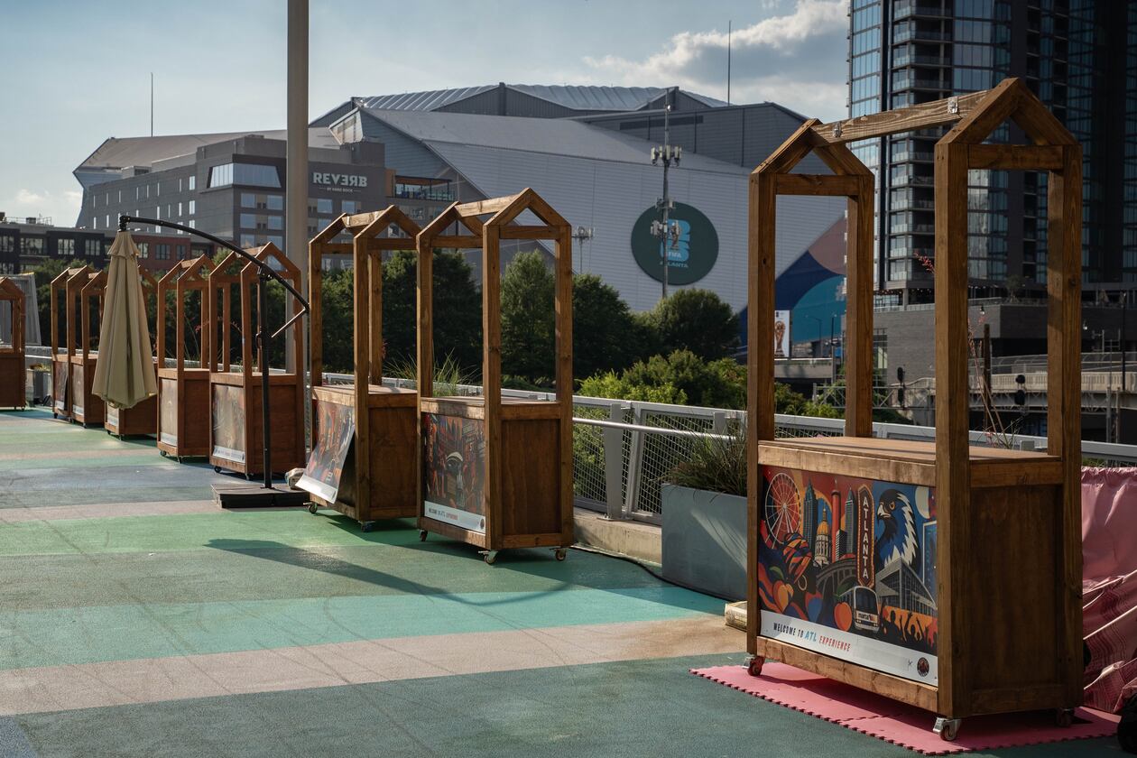 Vendor booths sit empty in the shadow of Atlanta Stadium (Mercedes-Benz Stadium) on the Steele Bridge in downtown Atlanta. (Ben Hendren for the AJC)