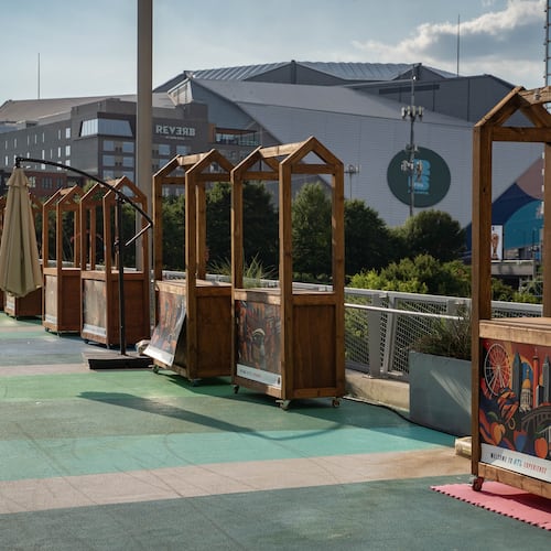 Vendor booths sit empty in the shadow of Atlanta Stadium (Mercedes-Benz Stadium) on the Steele Bridge in downtown Atlanta. (Ben Hendren for the AJC)