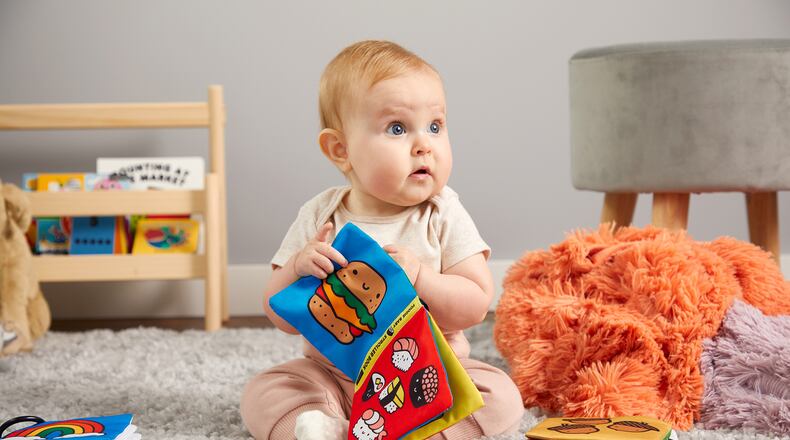 A colorful crinkle fabric book featuring emoji-like food entertains babies.
(Courtesy of Mudpuppy)