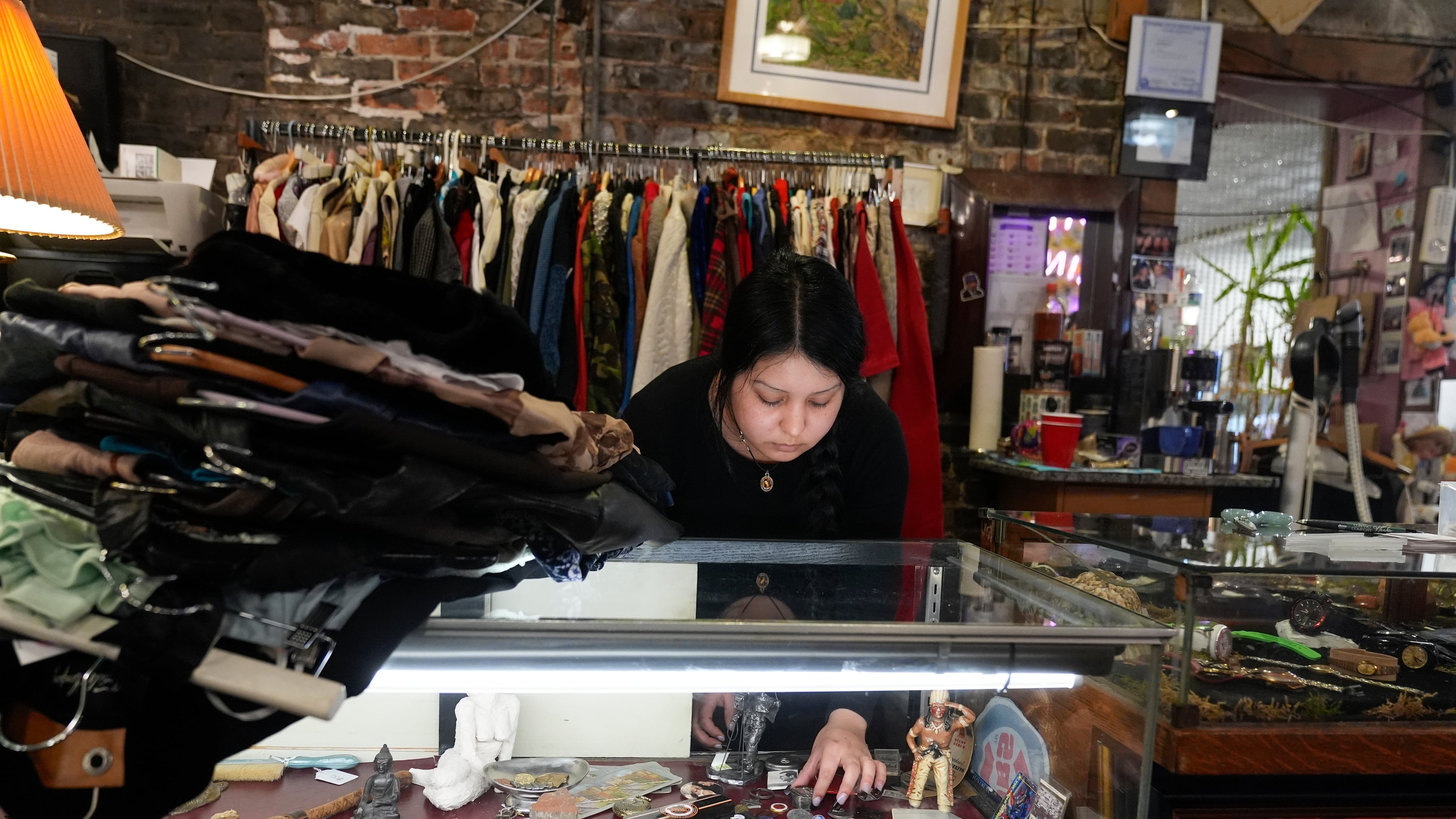 Satani Silva works at Pilsen Vintage, Wednesday, Nov. 19, 2025, in the Pilsen neighborhood of Chicago. (AP Photo/Erin Hooley)