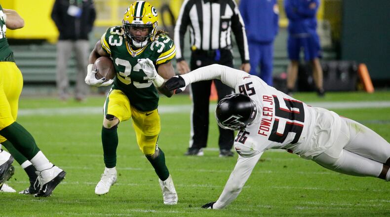 Packers RB Aaron Jones runs past Dante Fowler of the Falcons during the second half of Monday's game.
