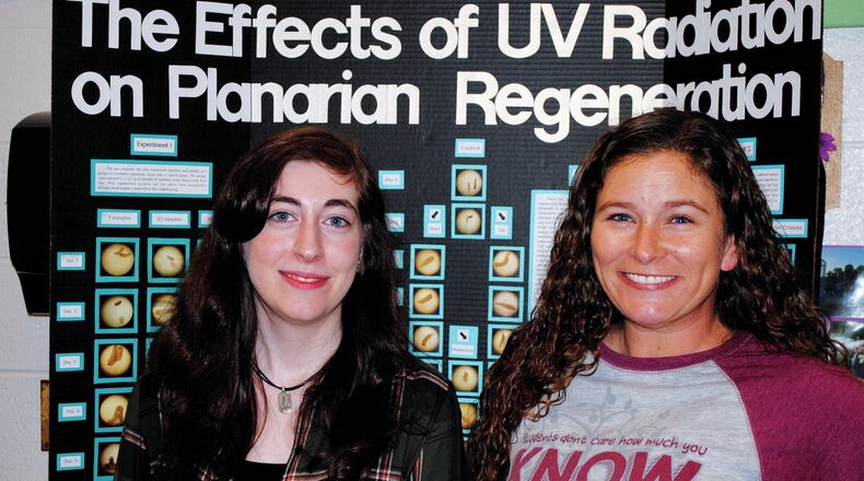 Julia Boll, left, is congratulated by her teacher and mentor, Henley Sawicki.