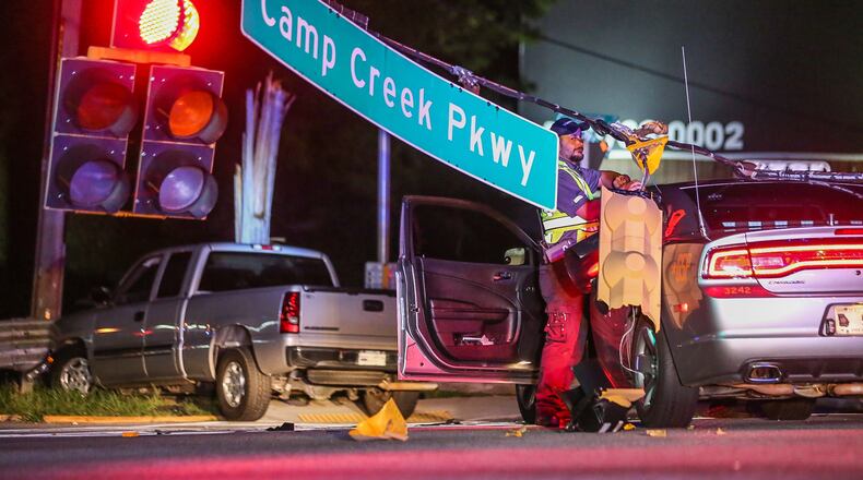 A predawn police chase Monday ended with a crash at the intersection of Camp Creek Parkway and Washington Road. JOHN SPINK / JSPINK@AJC.COM