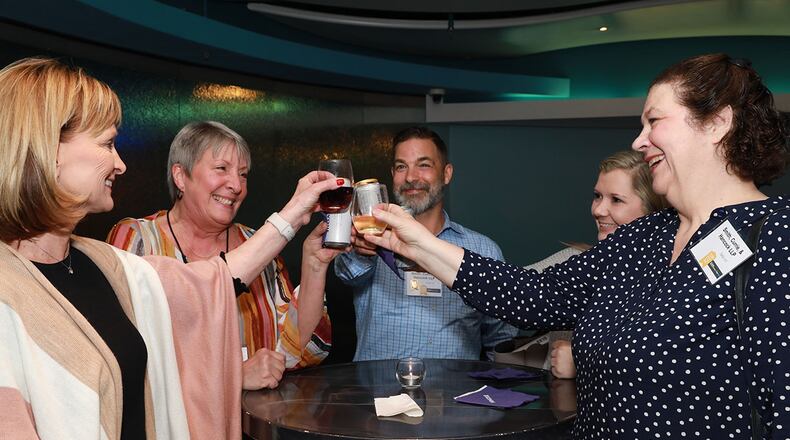 Smith Currie Hancock employees toast to their inclusion in the top small workplaces.