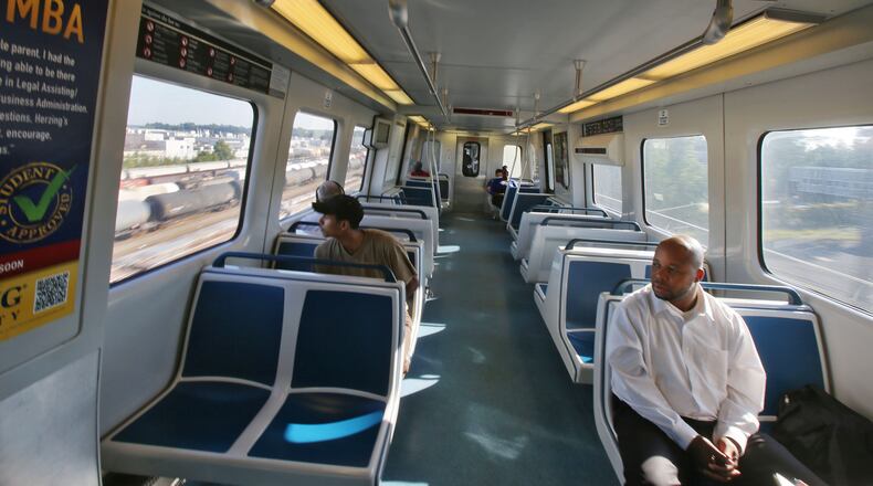Sep. 23, 2013 - Ric Jilla, (right) rides MARTA from the Doraville station into Atlanta. BOB ANDRES / BANDRES@AJC.COM