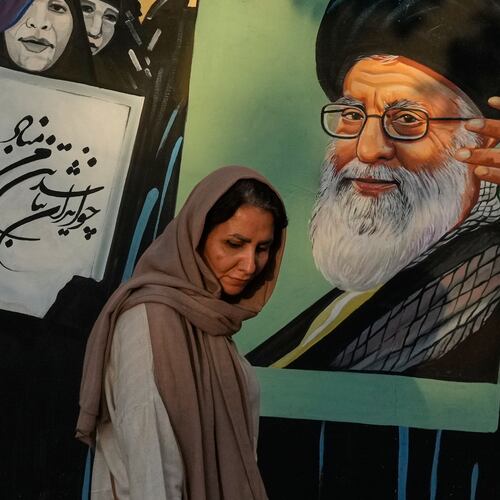 A woman walks past a mural depicting a portrait of the late Iranian Supreme Leader Ayatollah Ali Khamenei, who was killed in the U.S. and Israel strike on Feb. 28, in downtown Tehran, Iran, Saturday, July 18, 2026. (AP Photo/Vahid Salemi)