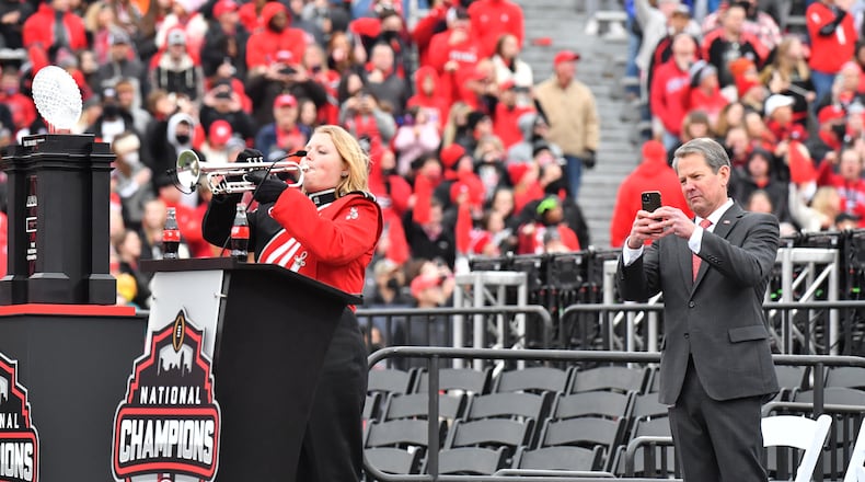 January 15, 2022 Athens - Governor Brian Kemp holds his iPhone as a lone trumpet player performs during the celebration of Georgia’s College Football Playoff national championship at Sanford Stadium in Athens on Saturday, January 15, 2022. Georgia captured the national championship, its first since the 1980 season, with a 33-18 victory over Alabama at Lucas Oil Stadium in Indianapolis. (Hyosub Shin / Hyosub.Shin@ajc.com)
