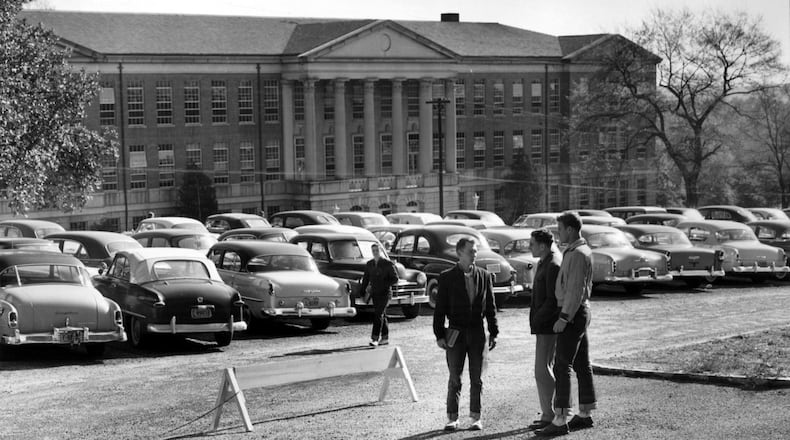 Human remains found during an expansion and renovation project at the site of the University of Georgia’s Baldwin Hall will be reburied in Oconee Hill Cemetery, officials announced this week.  The unpaved parking lot in front of the 77-year-old building is shown in this historic 1955 photo. (File photo)