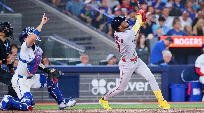 Boston Red Sox's Ceddanne Rafaela, right, flies into a sacrifice double play that was reviewed with a time play allowing Anthony Seigler (not shown) to score against the Toronto Blue Jays during the seventh inning of a baseball game in Toronto, Monday, Aug. 10, 2026. (Sammy Kogan/The Canadian Press via AP)