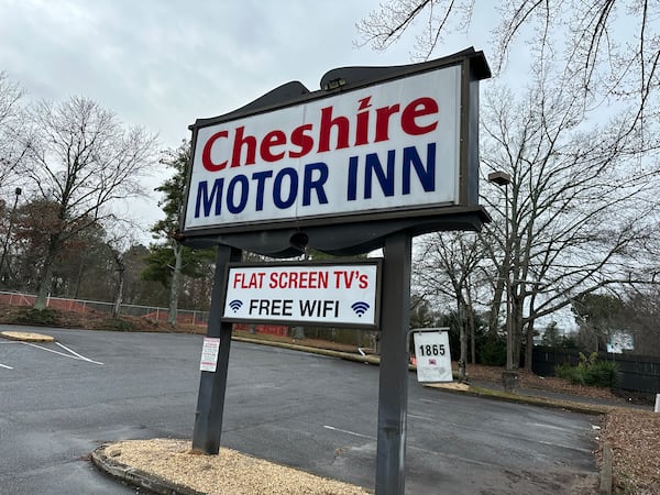 Cheshire Motor Inn opened in the late 1950s but closed in October 2025. The sign remains on Jan. 23, 2026, but the motel itself was already in rubble. (Rodney Ho/AJC)