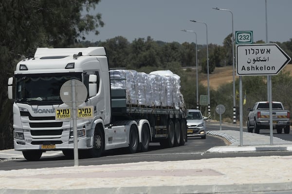 A truck loaded with humanitarian aid for the Gaza Strip makes its way to the Kerem Shalom crossing in southern Israel, in Israel-Gaza border, Tuesday, May 20, 2025. (AP Photo/Maya Alleruzzo)