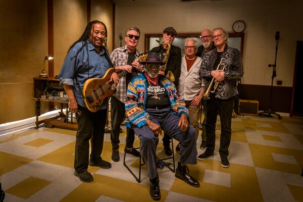 Backing Taj Mahal (seated) for his Thursday concert at Variety Playhouse will be the Phantom Blues Band, comprising (from left) Larry Fulcher, Johnny Lee Schell, Joe Sublett, Tony Braunagel, Jim Pugh and Les Lovitt. (Mike Coeyman)