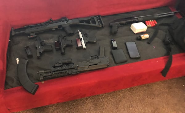These guns were seized from Teontre Crowley, who attempted to murder a man on Arthur's Corfield's orders. The victim, who Cofield considered a romantic rival, survived the 2018 drive-by shooting but was left paralyzed from the waist down. Crowley is serving 30 years in prison for the shooting. (Courtesy of the Fulton County District Attorney's Office)
