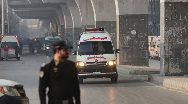An ambulance carrying injured people drive towards a hospital after suicide bombers attacked the headquarters of the Federal Constabulary (FC), in Peshawar, Pakistan, Monday, Nov. 24, 2025. (AP Photo/Muhammad Zubair)