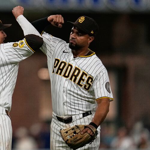 San Diego Padres third baseman Manny Machado (13) celebrates with shortstop Xander Bogaerts after the Padres defeated the Atlanta Braves 1-0 in a baseball game Monday, June 22, 2026, in San Diego. (AP Photo/Gregory Bull)
