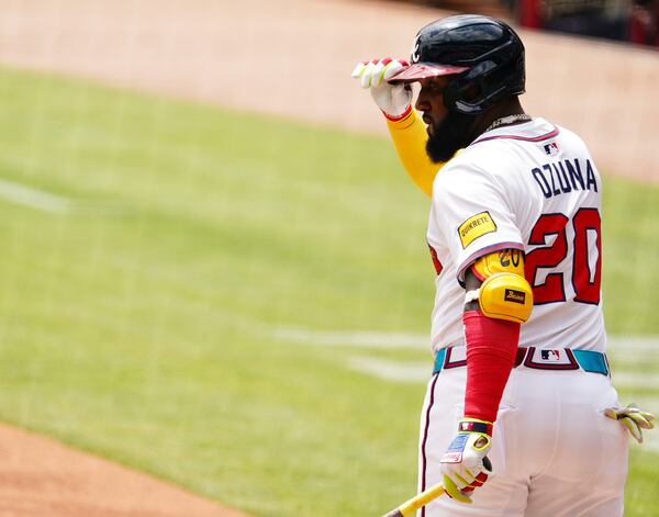 Atlanta Braves designated hitter Marcell Ozuna (20) tips his hat to the dugout while coming to the plate against the Minnesota Twins during the first inning of a baseball game Saturday, April 20, 2025, in Atlanta. (AP Photo/ John David Mercer)