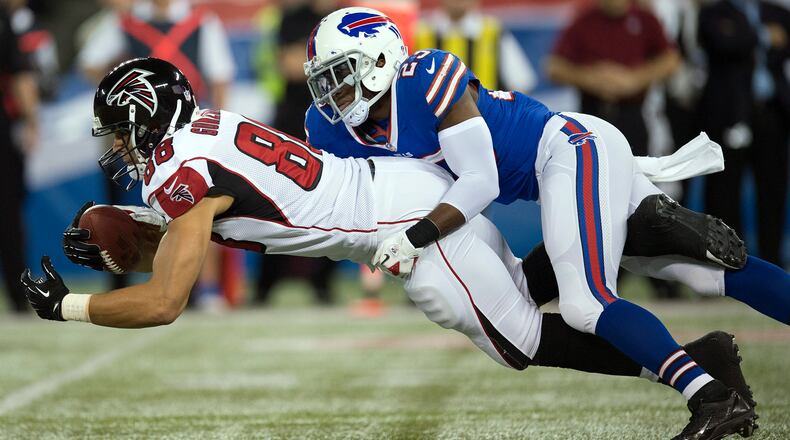 Buffalo Bills safety Aaron Williams (23) hauls down Atlanta Falcons tight end Tony Gonzalez (88) during first half NFL football action in Toronto on Sunday Dec. 1, 2013.