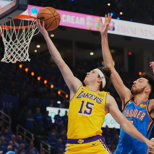 FILE - Los Angeles Lakers guard Austin Reaves (15) shoots after getting past Oklahoma City Thunder center Chet Holmgren, center, and Shai Gilgeous-Alexander, right, in the first half of Game 1 in a second-round NBA basketball playoffs series May 5, 2026 in Oklahoma City. (AP Photo/Kyle Phillips, File)