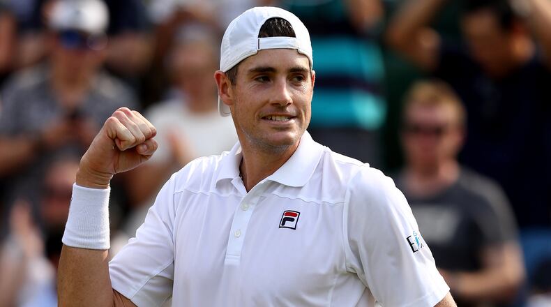 John Isner, a former star at Georgia, celebrates winning his men's singles fourth round against Stefanos Tsitsipas of Greece on day seven of the Wimbledon Lawn Tennis Championships at All England Lawn Tennis and Croquet Club on July 9, 2018 in London.