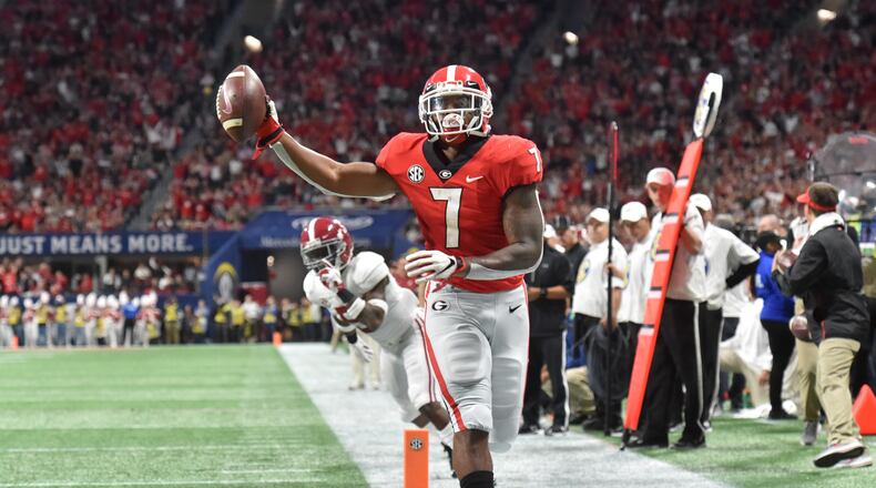 December 1, 2018 Atlanta - Georgia running back D'Andre Swift (7) scores past Alabama defensive back Shyheim Carter (5) during the first half of the SEC Football Championship at Mercedes-Benz Stadium on Saturday, December 1, 2018. HYOSUB SHIN / HSHIN@AJC.COM