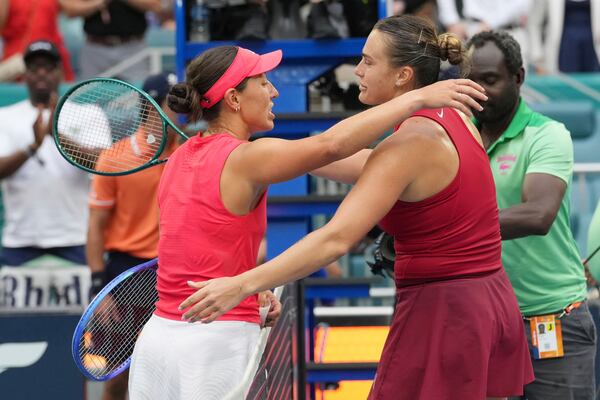 Jessica Pegula, left, and Aryna Sabalenka hug at the end of the women's singles final match at the Miami Open tennis tournament, Saturday, March 29, 2025, in Miami Gardens, Fla. (AP Photo/Marta Lavandier)