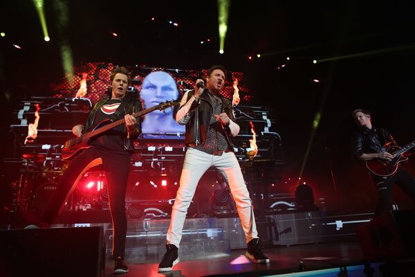  The band, with longtime guitarist Dominic Brown (far right), played Philips Arena in April 2016. (Akili-Casundria Ramsess/Special to the AJC)