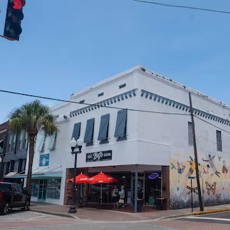 A three-quarter view of a historic building in downtown Brunswick with a mural on one side