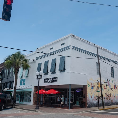 A three-quarter view of a historic building in downtown Brunswick with a mural on one side