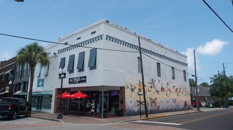 A three-quarter view of a historic building in downtown Brunswick with a mural on one side