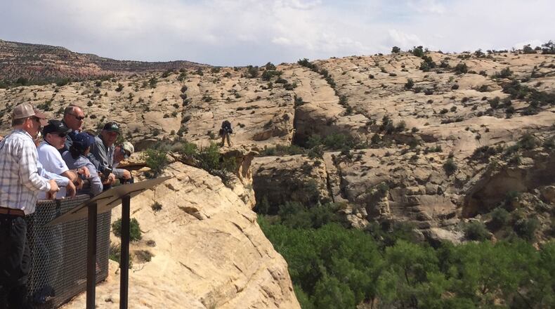 Interior Secretary Ryan Zinke, hatless and wearing sunglasses, looks at ancient native ruins in Bears Ears National Monument, Utah. (William Yardley/Los Angeles Times/TNS)
