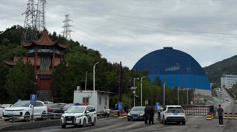 Police officers at a checkpoint stop cars at the entrance to the Liushenyu coal mine facility in Qinyuan county in Changzhi, northern China's Shanxi province on Sunday, May 24, 2026. (AP Photo/E. Eduardo Castillo)